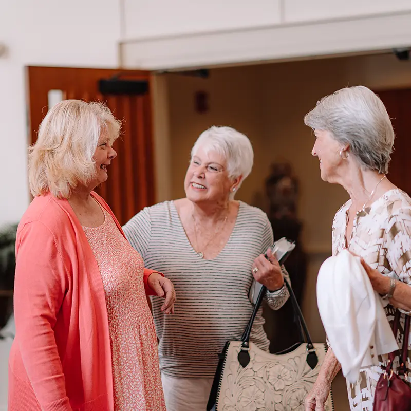 Three ladies talking in the church lobby